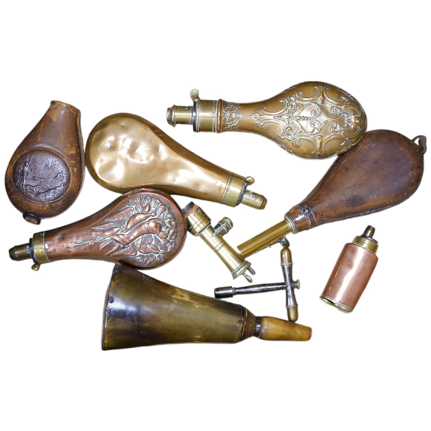 Four assorted copper powder flasks comprising; a three-way flask by Sykes (dented), ‘three horses head’ flask by Hawksley and two others, together with two leather shot flasks, a horn powder flask and a percussion nipple